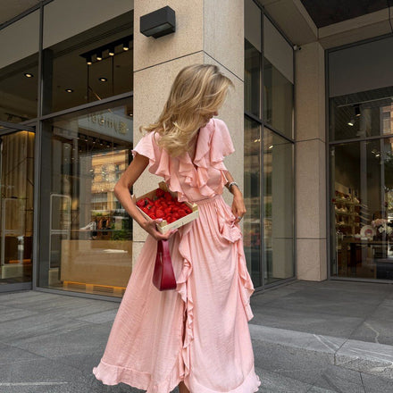 Ariane ruffle wrap maxi in pink on a city street