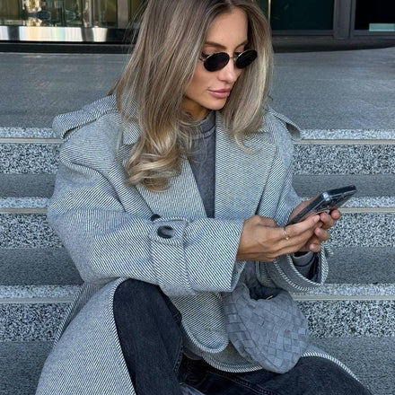 Marceline belted coat in grey on stone steps